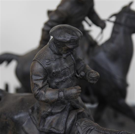 A 19th century Russian cast iron group of two huntsmen and five hounds, width 15in. height 11in.